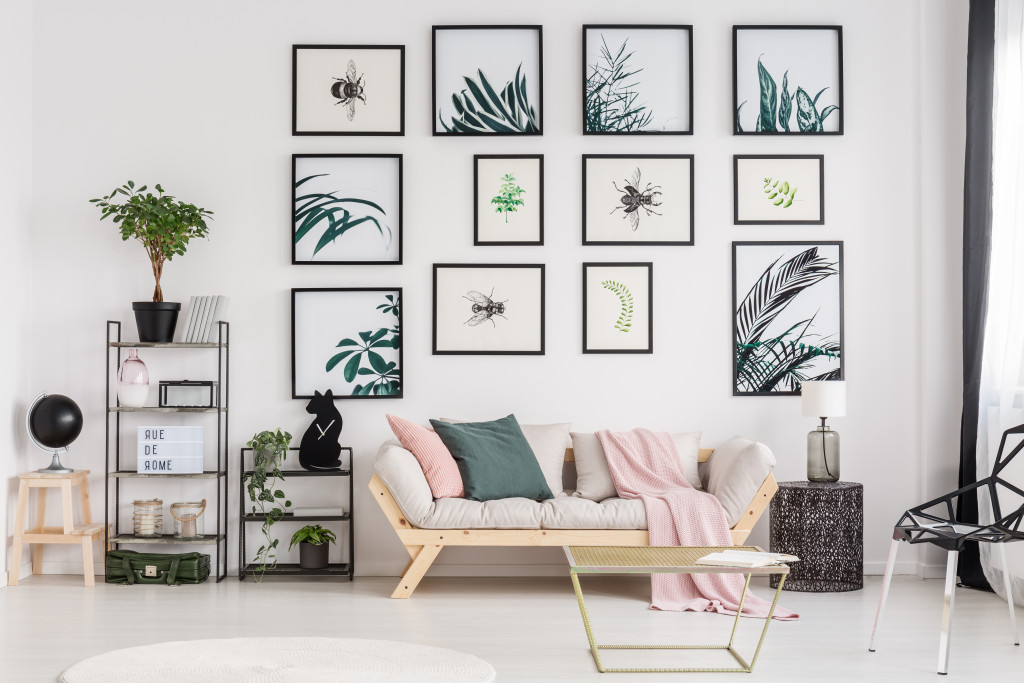 a living room decorated with art pieces depicting nature